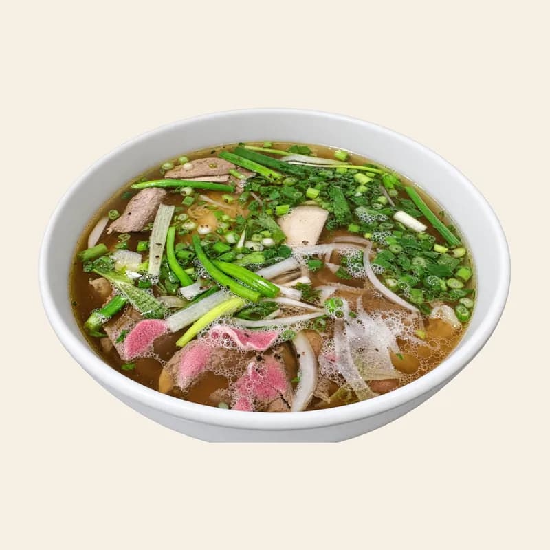 A bowl of special beef pho with rare steak, scallions and onion